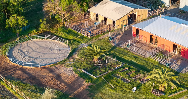 The circular round pen beside the barns